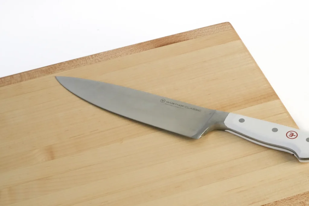 large maple cutting board with wusthof knife